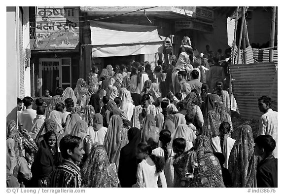 Street with women in colorful sari following wedding procession. Jodhpur, Rajasthan, India