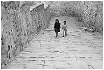 Children walking on the stone ramp leading to the fort. Jodhpur, Rajasthan, India (black and white)