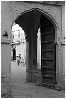 Archway with woman carrying water in courtyard. Jodhpur, Rajasthan, India ( black and white)