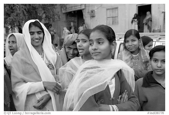 Women standing in the street during a wedding. Jodhpur, Rajasthan, India