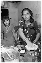 Woman and girl preparing chapati bread. Jodhpur, Rajasthan, India (black and white)