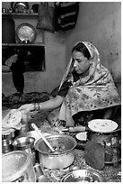 Woman with headscarf stacking chapati bread. Jodhpur, Rajasthan, India ( black and white)