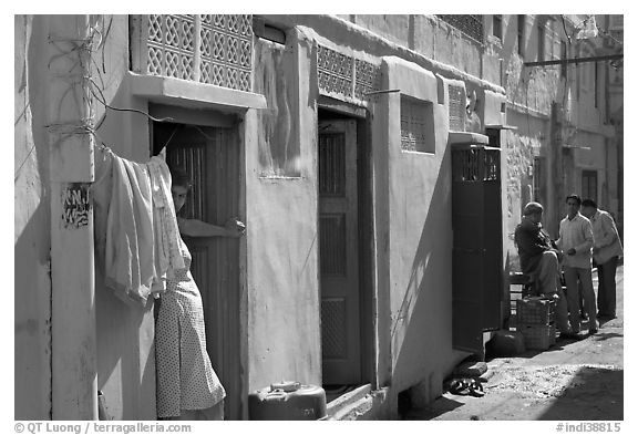 Sunlit street with blue house. Jodhpur, Rajasthan, India (black and white)
