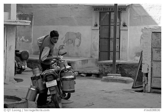 Man with milk delivery motorbike. Jodhpur, Rajasthan, India (black and white)