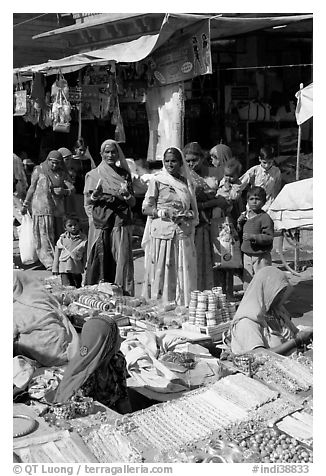 Women looking at jewelry stand in Sardar market. Jodhpur, Rajasthan, India (black and white)