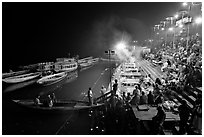 Boat and Dasaswamedh Ghat at the start of evening puja. Varanasi, Uttar Pradesh, India (black and white)
