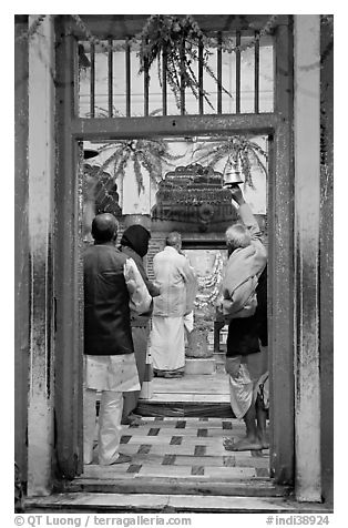 Bell ringing during worship in temple. Varanasi, Uttar Pradesh, India (black and white)