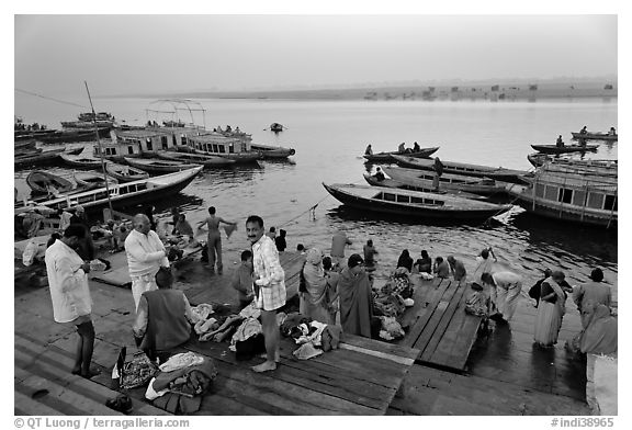 Men preparing for ritual bath on banks of Ganges River at dawn. Varanasi, Uttar Pradesh, India (black and white)