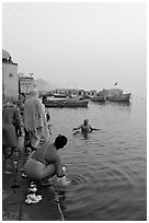 Hindu men dipping in the Ganges River at dawn. Varanasi, Uttar Pradesh, India ( black and white)