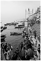 Boat unloading pilgrim onto Dasaswamedh Ghat, early morning. Varanasi, Uttar Pradesh, India ( black and white)