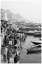 People and boats on the banks of the Ganges River, Dasaswamedh Ghat. Varanasi, Uttar Pradesh, India (black and white)