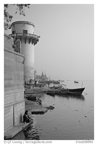 Man sitting on edge of Ganges River. Varanasi, Uttar Pradesh, India
