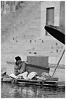 Man sitting near unbrella. Varanasi, Uttar Pradesh, India (black and white)
