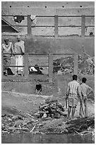 Men attending to cremation, Manikarnika Ghat. Varanasi, Uttar Pradesh, India (black and white)