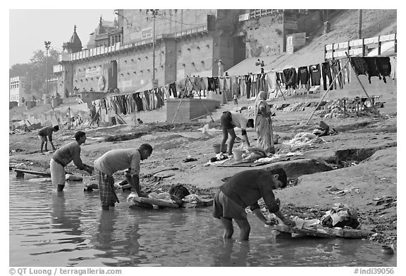 Men washing laundry on Ganga riverbanks. Varanasi, Uttar Pradesh, India