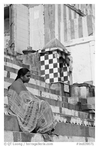 Woman sitting on temple steps. Varanasi, Uttar Pradesh, India (black and white)