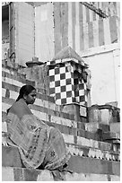 Woman sitting on temple steps. Varanasi, Uttar Pradesh, India (black and white)