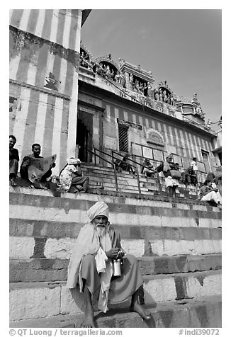 Holy man sitting on temple steps, Kedar Ghat. Varanasi, Uttar Pradesh, India (black and white)