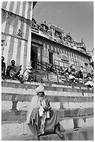 Holy man sitting on temple steps, Kedar Ghat. Varanasi, Uttar Pradesh, India (black and white)