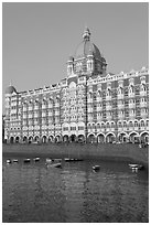 Taj Mahal Palace Hotel and small boats in harbor. Mumbai, Maharashtra, India ( black and white)