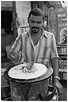 Man preparing breakfast dosa, Colaba Market. Mumbai, Maharashtra, India (black and white)