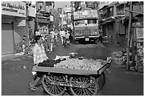 Vegetable vendor pushing cart with truck in background, Colaba Market. Mumbai, Maharashtra, India ( black and white)