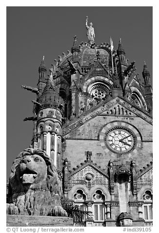 Lion and Gothic tower topped by 4m-high statue of Progress, Victoria Terminus. Mumbai, Maharashtra, India (black and white)