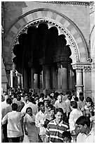 Crowd pass beneath an archway, Chhatrapati Shivaji Terminus. Mumbai, Maharashtra, India ( black and white)