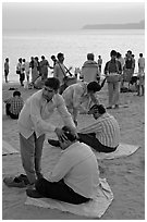Head rub given by malish-wallah, Chowpatty Beach. Mumbai, Maharashtra, India ( black and white)