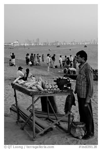 Food vendor on beach at dusk, Chowpatty Beach. Mumbai, Maharashtra, India (black and white)