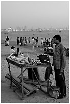 Food vendor on beach at dusk, Chowpatty Beach. Mumbai, Maharashtra, India ( black and white)