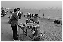 Food stall selling braised corn at twilight,  Chowpatty Beach. Mumbai, Maharashtra, India ( black and white)