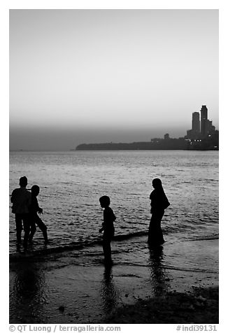 Beachgoers and skyline, Chowpatty Beach. Mumbai, Maharashtra, India (black and white)