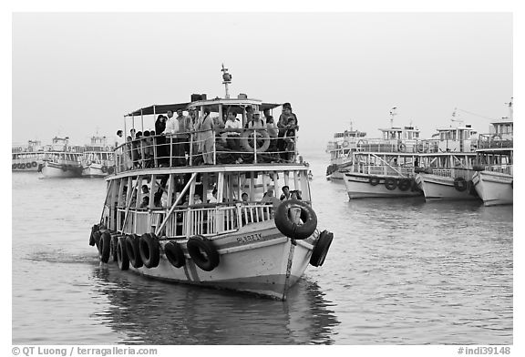 Tour boat loaded with passengers. Mumbai, Maharashtra, India (black and white)