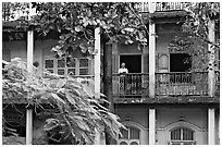 Facade with balconies and man reading. Mumbai, Maharashtra, India ( black and white)