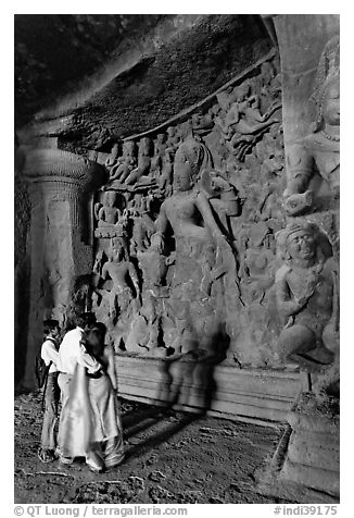 Family looking at Ardhanarishwar Siva sculpture, main Elephanta cave. Mumbai, Maharashtra, India (black and white)
