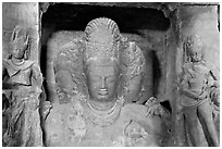 Trimurti flanked by pilasters with figures of dwarplalas, Elephanta caves. Mumbai, Maharashtra, India ( black and white)