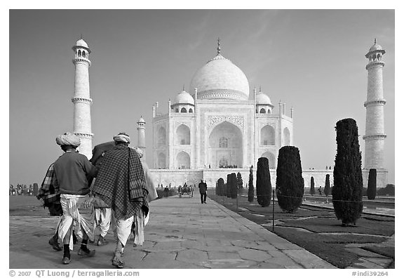 Men walking toward Taj Mahal, early morning. Agra, Uttar Pradesh, India (black and white)