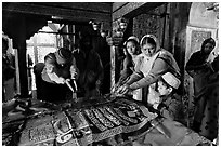 Women making offerings on Shaikh Salim Chishti tomb. Fatehpur Sikri, Uttar Pradesh, India (black and white)