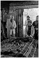 Family making offering on Shaikh Salim Chishti tomb. Fatehpur Sikri, Uttar Pradesh, India ( black and white)