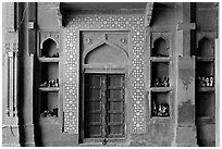 Wall with shoes stored, Dargah mosque. Fatehpur Sikri, Uttar Pradesh, India (black and white)