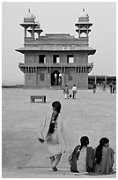 Women, Pachisi courtyard, and Diwan-i-Khas. Fatehpur Sikri, Uttar Pradesh, India ( black and white)