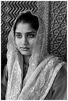 Young woman with embroided scarf, in front of Rumi Sultana wall. Fatehpur Sikri, Uttar Pradesh, India (black and white)