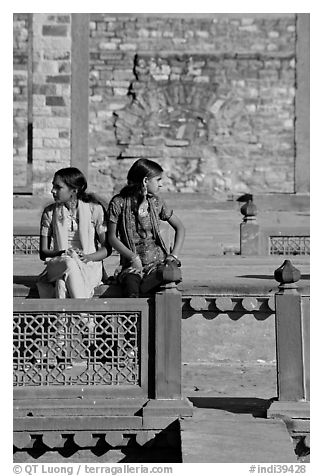 Young women sitting in the center of Ornamental pool. Fatehpur Sikri, Uttar Pradesh, India (black and white)