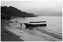 Narrow boat on beach at dawn, Dona Paula. Goa, India ( black and white)