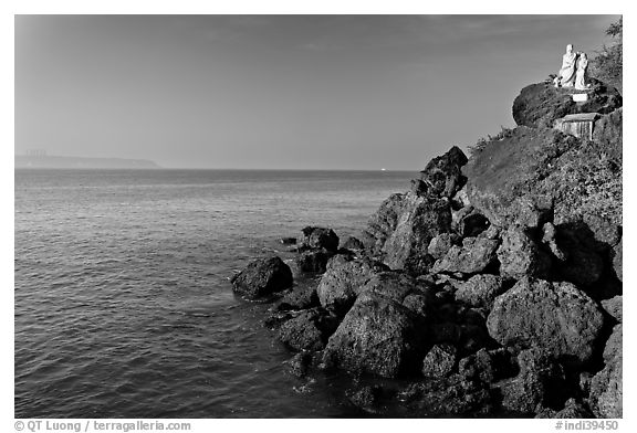 Boulders and christian statues at the edge of ocean, Dona Paula. Goa, India (black and white)
