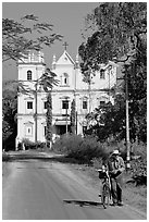 Man walking a bicycle in front of church of St John, Old Goa. Goa, India ( black and white)
