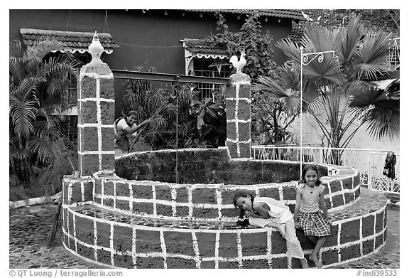 Woman and girls at communal well, Panjim. Goa, India (black and white)