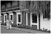 Women strolling past the heritage Panaji Inn, Panjim. Goa, India ( black and white)