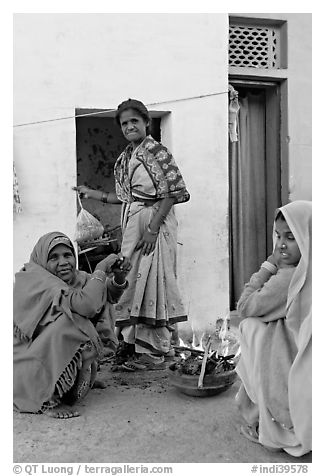 Women cooking outside in village. Khajuraho, Madhya Pradesh, India